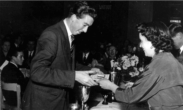 Club dinner 1954. Receiving medals from Mrs Sharpe.   